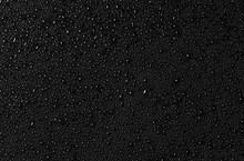 Water Drops On Black Glass Surface. Texture. Top View