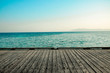 gray wooden deck of pier and blue summer sea with sky