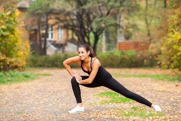 Young beautiful woman doing exercise on park