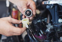 Mechanic Man Open Cap And Check Brake Fluid On Motorcycle In Garage, Motorcycle Maintenance And Service And Repair Concept