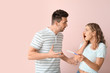 © Pixel-Shot - Emotional young couple with pregnancy test on color background