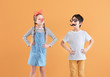 Little children in funny disguise on color background. April fools' day celebration