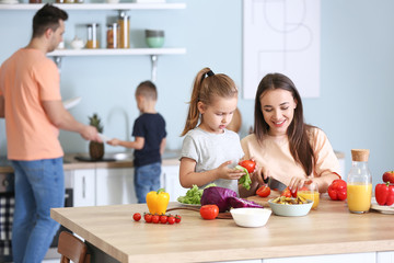 Wall Mural - Mother with daughter cooking together in kitchen