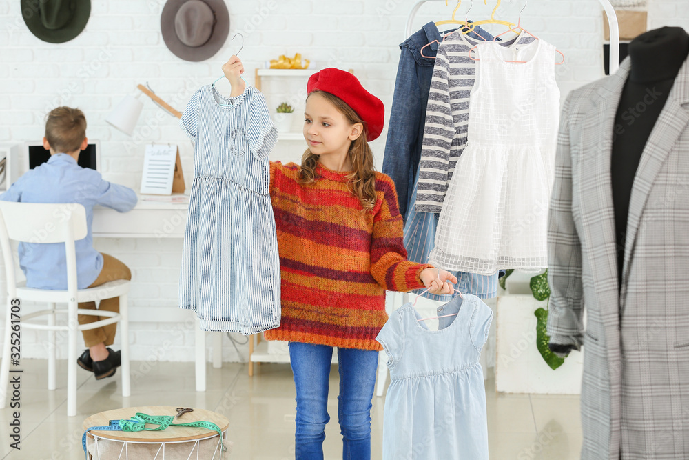 Cute little tailor working in atelier