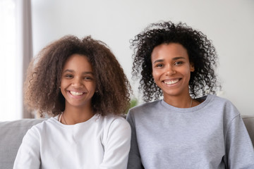 Wall Mural - Happy african american mother and teen daughter vloggers recording vlog