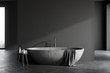 Stone bathtub in spacious grey bathroom