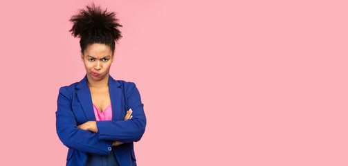 Portrait of offended black woman with folded arms