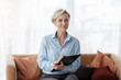 © Prostock-studio - Psychologist Holding Folder Sitting On Sofa In Office