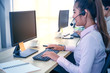 © Pataradon - Young customer service women agent with headsets and computer working at office.