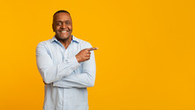 African American Mature Man Pointing Aside At Empty Space