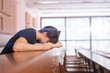 © Mihail - male caucasian person sitting and feeling tired in the lecture hall auditorium, overworking stress