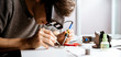 © Mihail - close up cropped shot of the engineer soldering electric components details and assemble the device