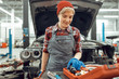 Pleased Caucasian female mechanic choosing rubber spacers