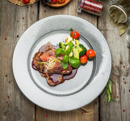 Medallions of veal, with sauce on a plate.