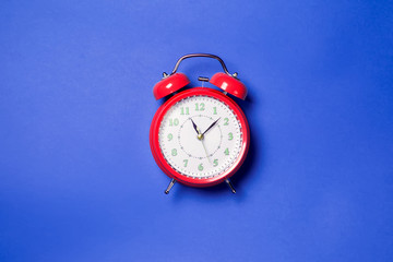 Alarm clock on the color background.