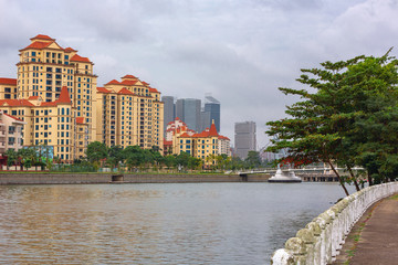 embankment in Singapore along the river channel on the background of the city landscape