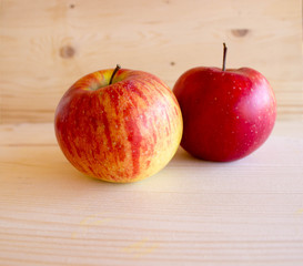 red tasty Sicilian apples on the on the wooden background, top view. Healthy lifestyle, vitamins and Mediterranean diet.