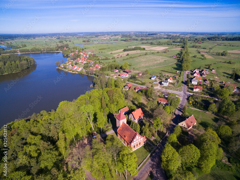 Aerial view of beautiful Kuty village (former Kutten, East Prussia) located on Czarna Kuta Lake shore, Mazury, Poland - obrazy, fototapety, plakaty 
