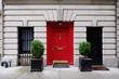 Beautiful building. Entrance red door, Manhattan New York, USA. Classic apartment estate in New York City. Beautiful view of midtown property, NYC. Business and finance, luxury life background.