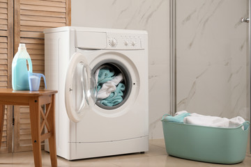 Canvas Print - Modern washing machine with towels in bathroom