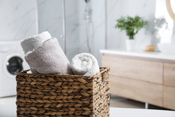 Wall Mural - Wicker basket with clean soft towels in bathroom. Space for text