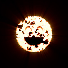 Symbol laugh beam burned on a black background. Bright shine