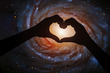 Sticker - spiral galaxy in heart shaped hands of astronaut in space. romantic vector illustration with hand si