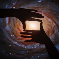 Poster - spiral galaxy in framing hands of astronaut in space. vector illustration with hand silhouette and a