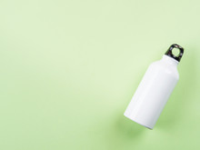 Zero Waste Concept - White Metal Reusable Water Bottle Flat Lay On Green Pastel Background