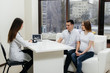 © Andrii - A young couple waiting for a baby to consult a gynecologist after an ultrasound. Pregnancy, and health care