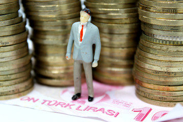 mimiature people with coins and car. Miniature businessman walking through a toy car. Concept of financial, retail, money saving and business. Car mortgage related