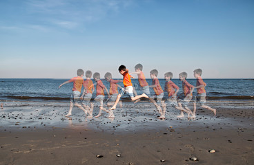 Wall Mural - Boy leaping in motion on a beach