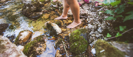 Children adventure at forest creek in nature