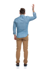 Poster - Rear view of a bothered casual man arguing and gesturing