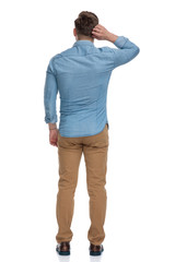 Poster - Rear view of a thinking casual man scratching his head