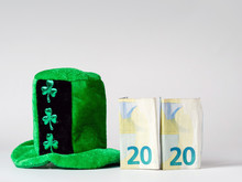Green Hat With Shamrock Two Euro Banknotes Folded Making 2020 Year Saint Patrick Day Celebration. Bright Background, Copy Space.