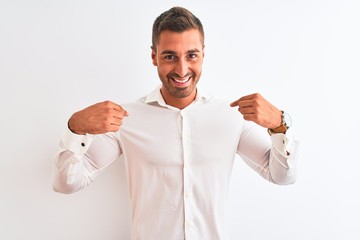 Canvas Print - Young handsome business man wearing elegant shirt over isolated background looking confident with smile on face, pointing oneself with fingers proud and happy.