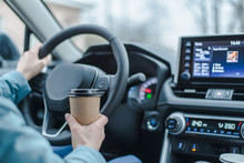 Close Up Young Girl Car Driver Drink Coffee, Hand Holding A Paper Cup Of Coffee. Travel With Coffee.  Concept Of Coffee With You. Mockup