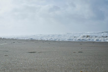 Down On The Sand Of The Cold White Beach On The Oregon Coast. 