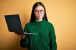 Young asian business woman wearing glasses and working using computer laptop skeptic and nervous, frowning upset because of problem. Negative person.