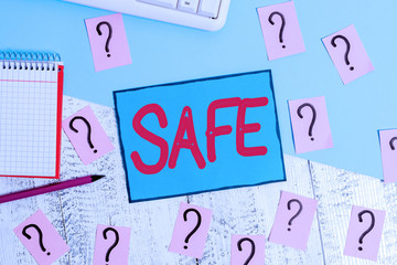 Leinwandbilder - Text sign showing Safe. Business photo text protected from or not exposed to danger or risk Not likely to be harmed Writing tools, computer stuff and math book sheet on top of wooden table