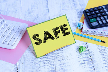 Leinwandbilder - Word writing text Safe. Business photo showcasing protected from or not exposed to danger or risk Not likely to be harmed Notepaper stand on buffer wire in between computer keyboard and math sheets