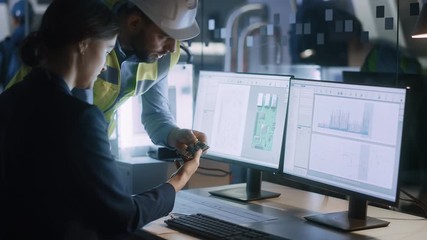 Poster - Electronics Design Factory Office: Female Engineer and Male Specialist Talking, Working on PC, Developing Industrial Microchips, Semiconductor, Telecommunications Equipment. Manufacturing Processors