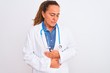 © Krakenimages.com - Middle age mature doctor woman wearing stethoscope over isolated background with hand on stomach because nausea, painful disease feeling unwell. Ache concept.