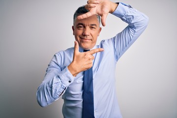 Poster - Middle age handsome grey-haired business man wearing elegant shirt and tie smiling making frame with hands and fingers with happy face. Creativity and photography concept.