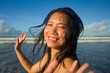 © TheVisualsYouNeed - natural lifestyle portrait of young attractive and happy Asian Chinese woman in swimsuit walking on beautiful beach paradise feeling relaxed and cheerful enjoying holidays