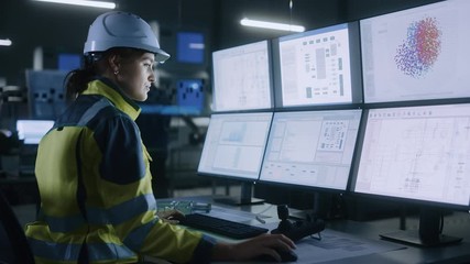 Leinwandbilder - Industry 4.0 Modern Factory: Female Facility Operator Controls Workshop Production Line, Uses Computer with Screens Showing Complex UI of Machine Operation Processes, Controllers, Machinery Blueprints
