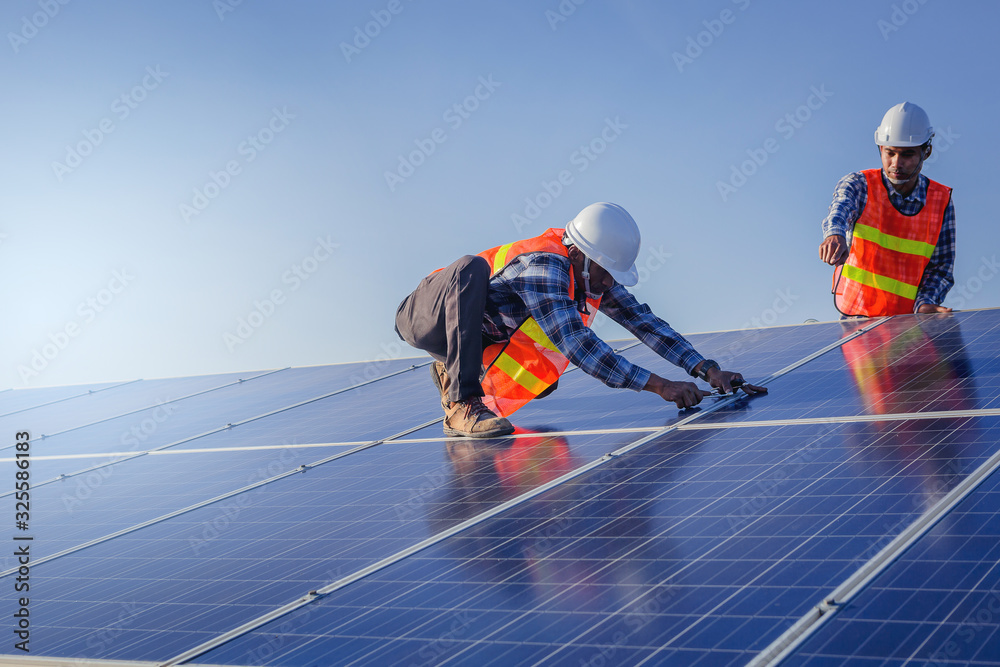 Electrical, instrument technician use wrench for fix and maintenance electrical system at solar panel field - obrazy, fototapety, plakaty 