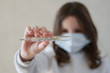© ruslanshug - coronavirus danger COVID-19 epidemic outbreak quarantine concept of little girl in medical mask holding thermometer with high level of temperature