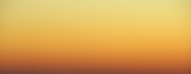 Wall Mural - flaming sky over the horizon during sunset or sunrise. bright iridescent colors of yellow, orange an